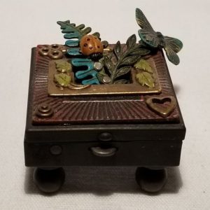 Metal box with leaves, butterfly and lady bug